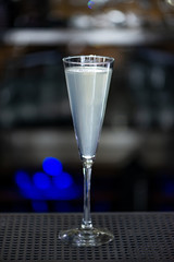 Grey Goose Le fizz cocktail at bar counter in night club or restaurant. Close-up.