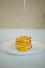 Sweet Homemade Stack of Pancakes with honey.