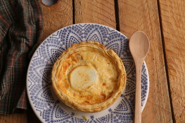 Delicious three cheese quiche in colored background