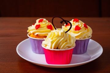 Cupcakes for Valentine's Day. Muffins decorated with hearts and delicious cream.