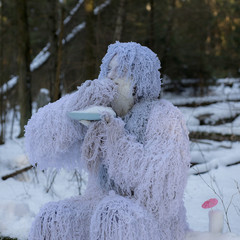 Yeti fairy tale character in winter forest.