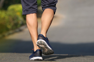 Foot of back men jogger outdoor  in the park lifestyle for exercise in morning good healthy protect...