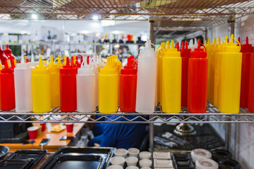 Empty plastic containers, bottles for mayonnaise mustard sauce and ketchup. Gravy boats for a restaurant.