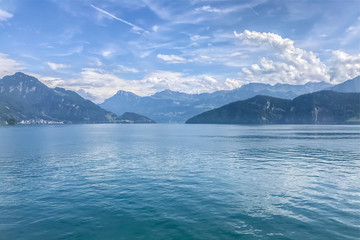 Gorgeous views on big blue lake with mountains in background and dramatic sky, breathtaking landscape