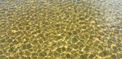 Beautiful clear water with light ripples of a summer lake