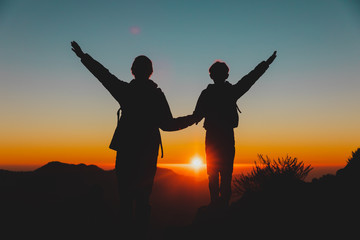 Father and son travel in sunset mountains, family hiking