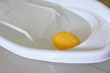 baby bathtub with support seat of newborn sitting in water and soft sponge