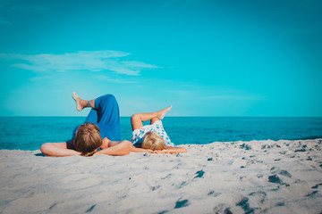 happy mom with little daughter relax on beach