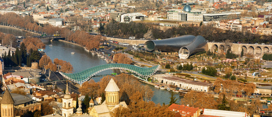 Beautiful view of Kura river and Bridge of Peace in Tbilisi. Bridge is a bow-shaped pedestrian bridge in Tbilisi © Ruslan Gilmanshin