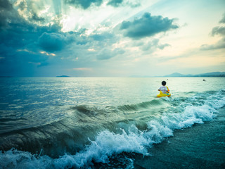 A boy swims in the sea