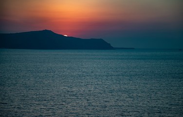 Fototapeta premium Santorini sunset from Fira, capital of the Greek Aegean island, Greece