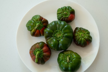 Raw ripe green organic bell peppers ready in a plate
