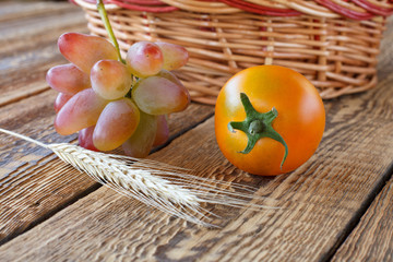 Tomato close-up over the wooden natural background