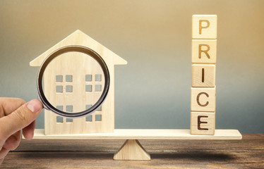 Wooden house and the word Price on the scales. Fair valuation property concept. Home appraisal....
