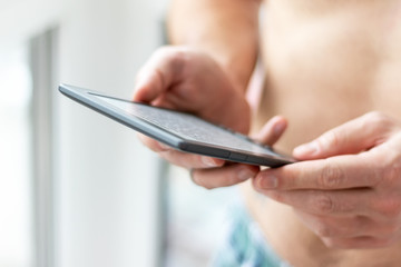 Men's hands with modern e-book closeup. Selective focus