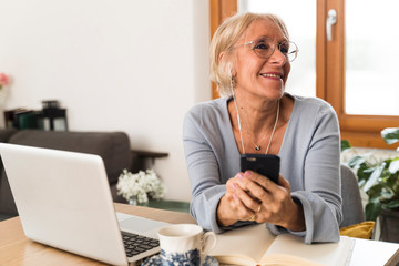 smiling woman listening to the music at home