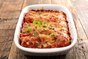 pasta gratin with beef, tomato sauce and cheese- traditional canneloni
