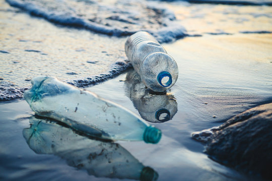 environmental pollution, used plastic bottles floating in ocean