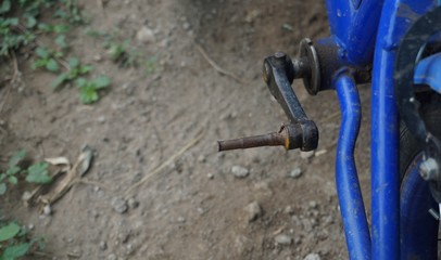 Old broken pedals and rusty children's bicycle.