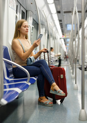 Fototapeta na wymiar Woman using phone inside subway