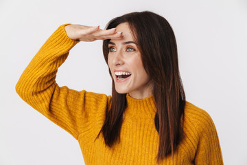 Image of excited adult woman looking aside with hand at her forehead