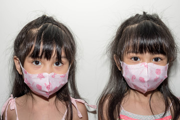 Coronavirus and Air pollution concept.Little asian girl wearing mask for protect with mask for...