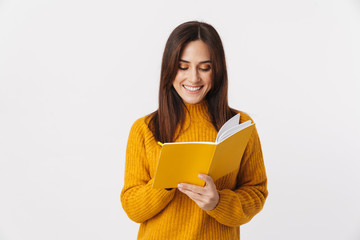 Image of beautiful brunette adult woman making notes in diary book