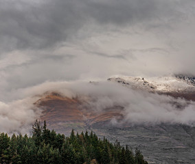 Fototapeta na wymiar Queenstown New Zealand. Clouds. Snow. Mountains