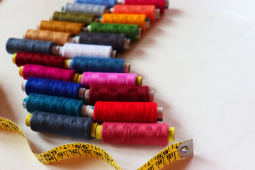 Fototapeta na wymiar colorful spools of sewing thread on a white background
