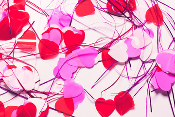 Colorful confetti in a heart shape on white background. Valentine day concept. Abstract backdrop