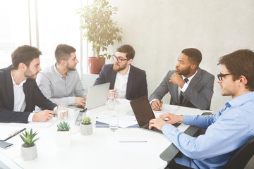 Fototapeta premium Businessmen having group meeting, discussing new project