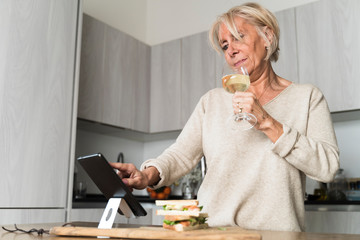 tasting a good wine while using a tablet