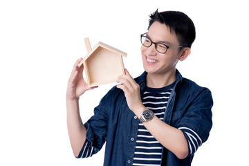 business insurance communication ideas concept with asian attractive male casual tshirt hand hold wooden house model box smile and happiness hand gesture pose present point show joyful moment