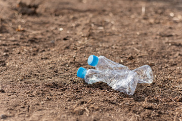 Fototapeta na wymiar Plastic bottle waste is thrown on the ground, - reuse concept.