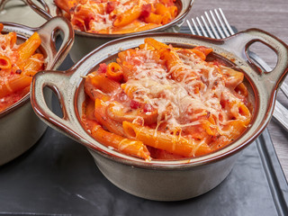 Oven baked penne rigatte with tomato sauce, mozarella and ham (pasta al forno), homemade