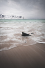 Famous Ramberg beach in lofoten islands. Long exposure shots. Ocean color in contrast with winter color in backgroud and sand of the beach. Near by famous red cabin