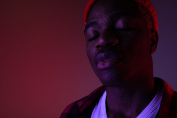 portrait of a stylish handsome american black man in neon light