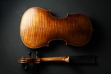 antique violin for restoration on a dark background close-up