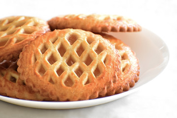 Mini apple tarts with apple filling on a white plate. Selective focus. 