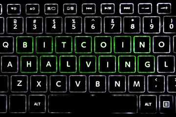 Words BITCOIN HALVING written with LED backlit keyboard buttons.