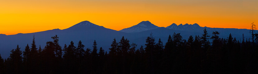 Colorful panoramic view after sunset with Mt Bachelor and Sisters Mountains near Bend in central...