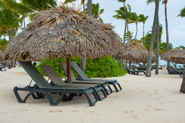 chaise longs and parasol beach on the ocean. Windy weather summer