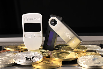 WROCLAW, POLAND - JANUARY 28, 2020: Physical version of Bitcoin (BTC), Trezor and Ledger...