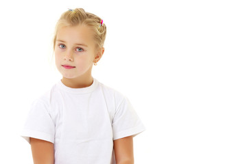 A little girl is sitting on the floor in a clean white T-shirt.
