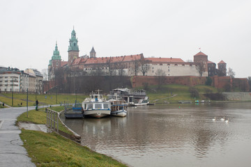 Obraz premium The most famous Polish Royal Cracow Wawel Castle on Christmas Day in rainy weather.