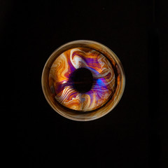 Colorful creative sphere soap bubble floating with a black background