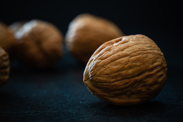 Walnuts on a black background - dark food photography