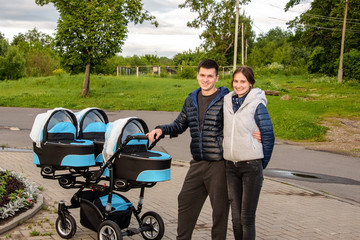 Happy couple walking with their triplets