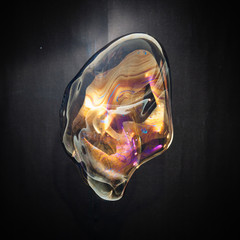 Colorful creative amorphous soap bubble floating with a black background