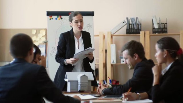 Businesswoman loudly swears at their employees, watching their reports and outraged